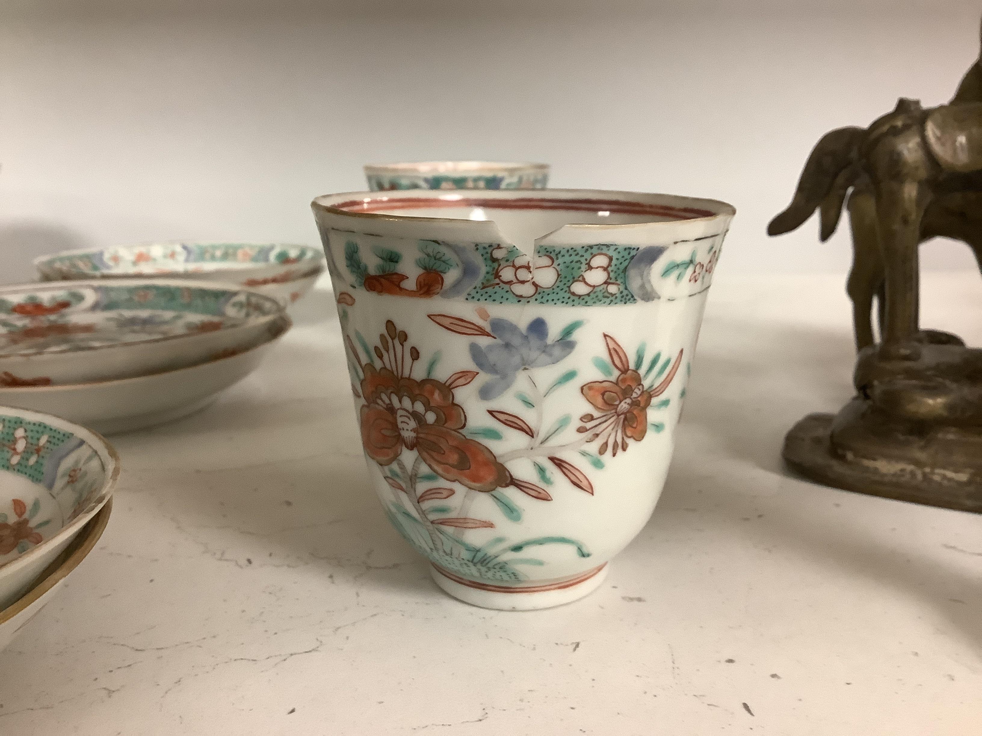 A set of six early 18th century Chinese cups and saucers with Dutch enamelled decoration, c.1710, 7.5cm high